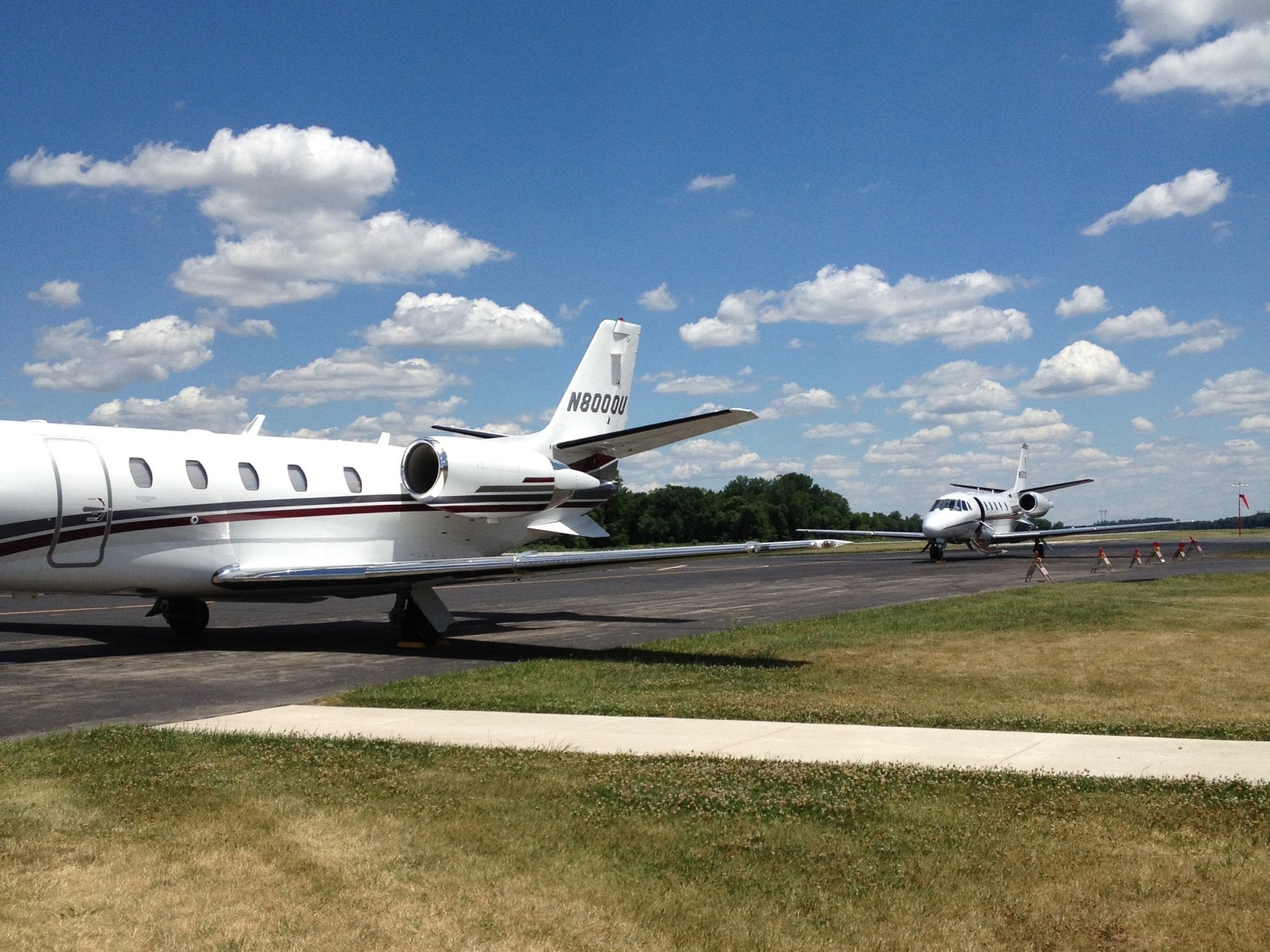 Business jets lined up on the runway